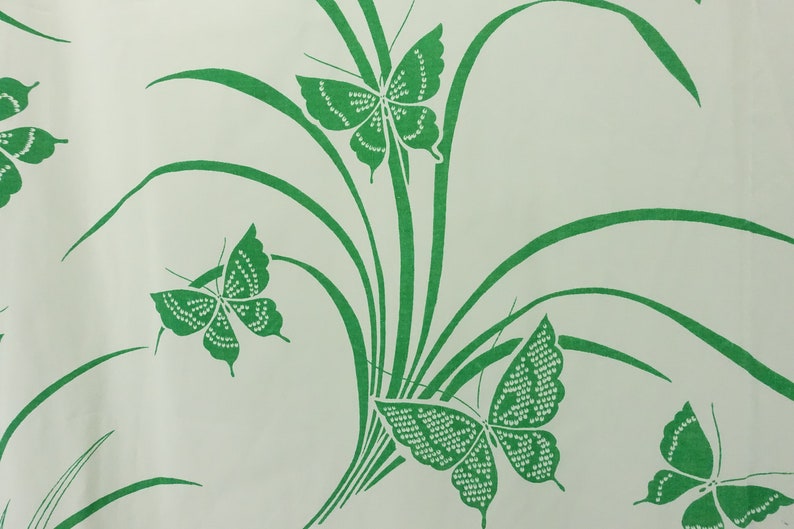 May include: A white background with a green pattern of butterflies and grass.