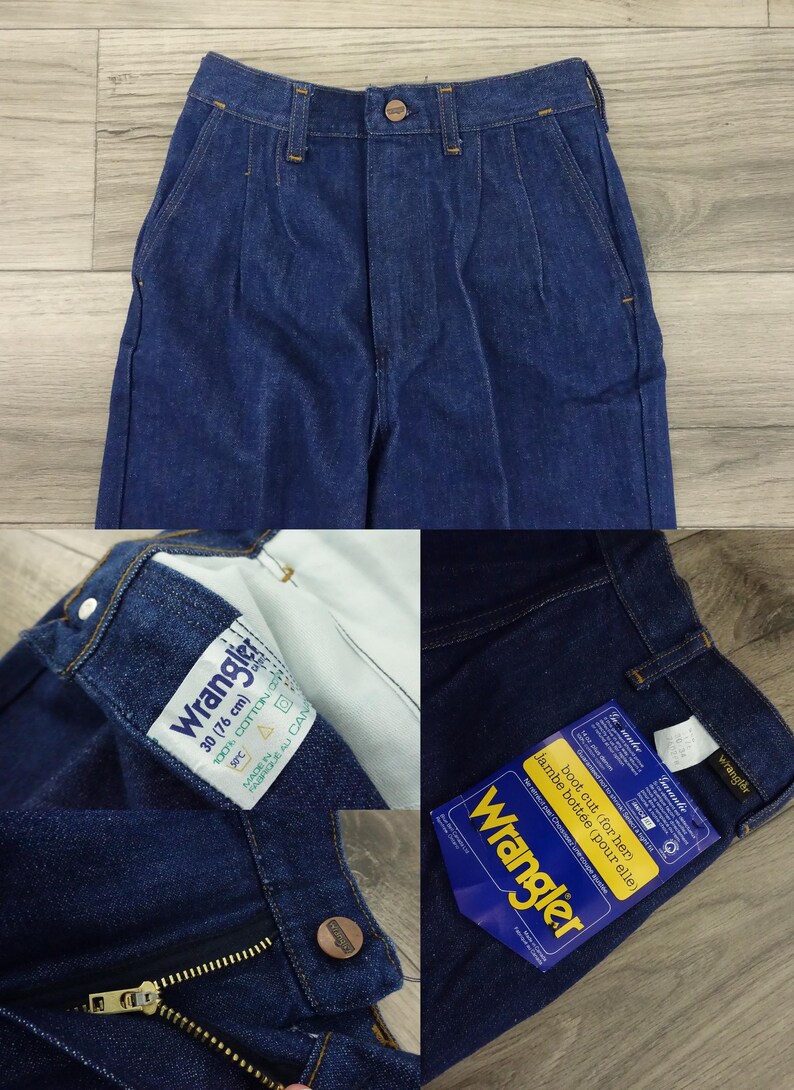 May include: A pair of blue denim Wrangler jeans with a boot cut leg. The jeans have a zipper fly and a button closure. The size tag says "30 (76 cm)" and "100% Cotton".
