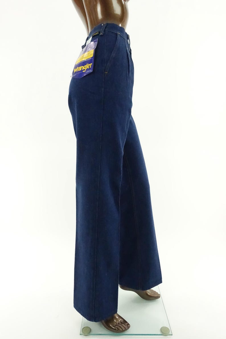 May include: A pair of dark blue denim jeans with a wide leg, featuring a
