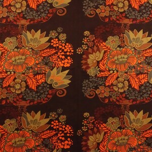 May include: A brown fabric with a repeating pattern of orange, brown, and green flowers in a vase. The fabric has a vintage feel.