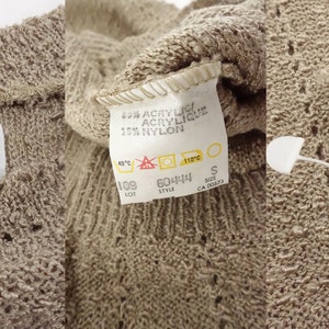 May include: A beige knitted cardigan with a label that reads "Lady Anne" and "Made in Canada - Fabriqu&eacute; au Canada". The label also includes the size "S" and the fabric content: "62% Acrylic, 18% Nylon".