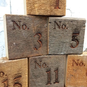 May include: Wooden blocks with the numbers 1, 3, 5, 11, and 15. Each block has the word "No." before the number.