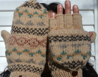 May include: Beige and patterned knit convertible mittens. The mittens have a flap that can be worn over the fingers or flipped back to expose the fingers. The mittens have a brown button closure at the wrist and are decorated with geometric patterns in brown, teal, and pink.