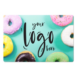 May include: A turquoise background with six colorful donuts, including pink, white, green, yellow, and chocolate. The text "your logo here" is written in black cursive.