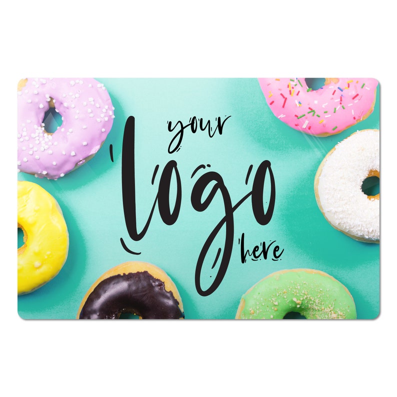 May include: A turquoise background with six colorful donuts, including pink, white, green, yellow, and chocolate. The text "your logo here" is written in black cursive.