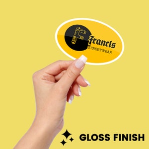 May include: A yellow oval sticker with a black and white logo that says "Francis Streetwear". The logo features a stylized letter "F" with a design resembling a tool. The sticker has a gloss finish.