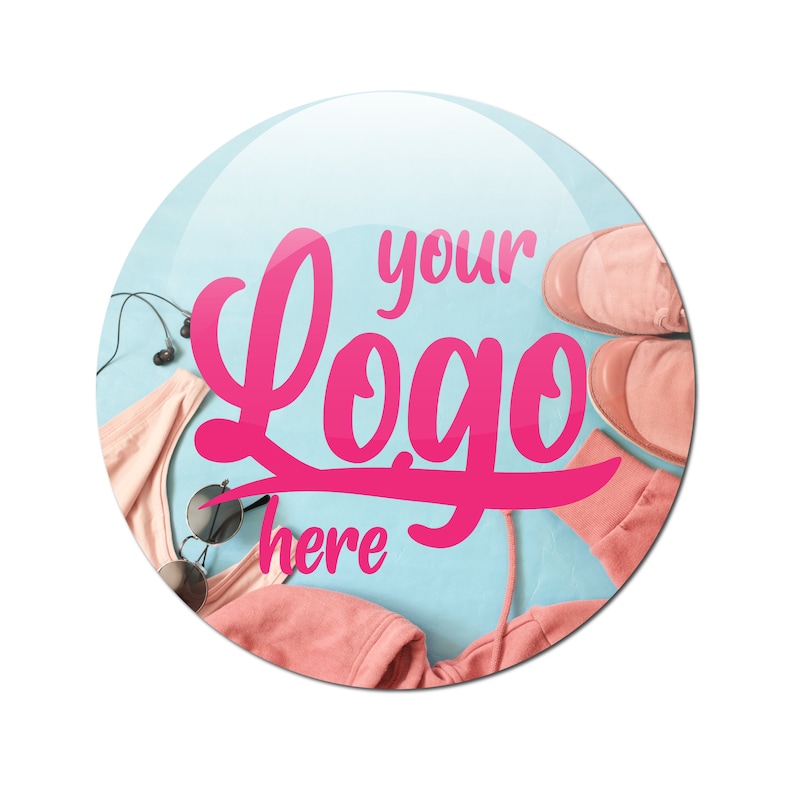 May include: A round, light blue background with a pink "your logo here" graphic. The background also features pink clothing items, sunglasses, and headphones.
