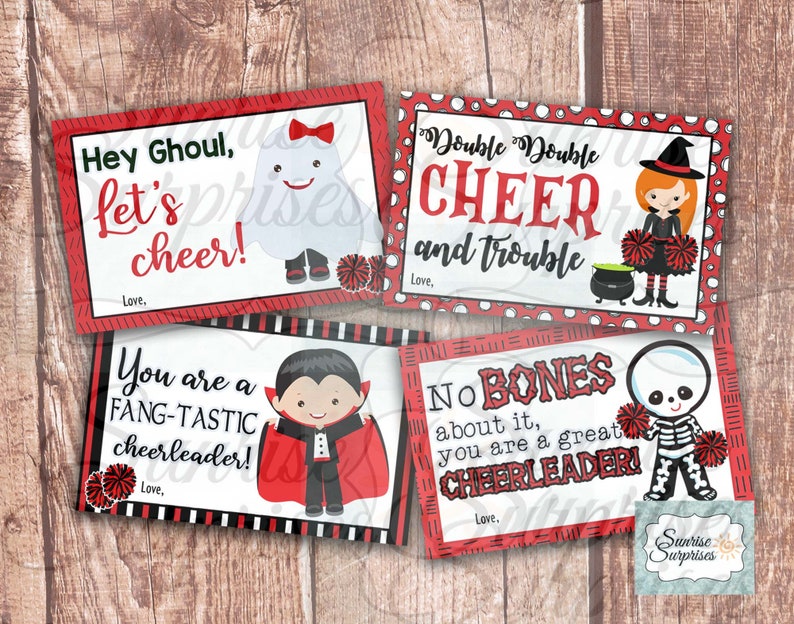 May include: Four printable Halloween-themed cheer cards with red, black, and white backgrounds. The cards feature a ghost, a witch, a vampire, and a skeleton holding cheer pom-poms. The cards have text that says "Hey Ghoul, let's cheer!" "Double Double Cheer and Trouble" "You are a Fang-Tastic Cheerleader!" and "No Bones about it, you are a great Cheerleader!"