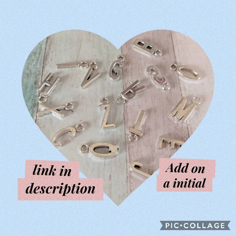 May include: Silver-colored alphabet charms in various letter styles, scattered on a heart-shaped background. The image includes the letters H, V, G, B, Z, T, Q, M, E, and C. Text on the image reads "link in description" and "Add on a initial".