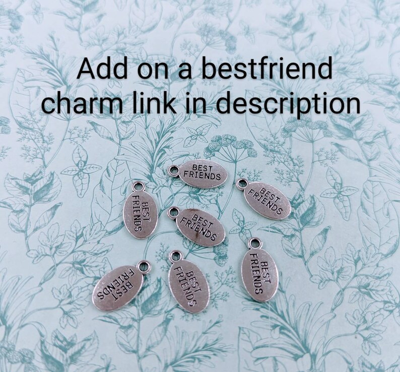 May include: Seven silver oval charms, each with the text "Best Friends" inscribed on them.