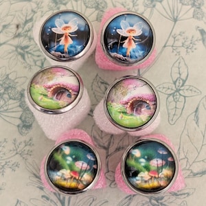 May include: A set of three ceramic mugs with a speckled, matte finish. The mugs are in shades of cream, light gray, and dark gray. Each mug has a simple, minimalist design and a rounded handle.