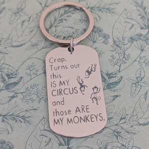 May include: Silver-colored metal keychain with a rectangular tag. The tag has the text "Crap. Turns out this IS MY CIRCUS and those ARE MY MONKEYS." and features three monkey illustrations.