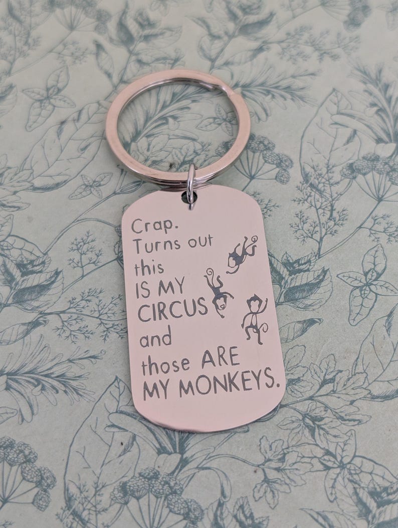 May include: Silver-colored metal keychain with a rectangular tag. The tag has the text "Crap. Turns out this IS MY CIRCUS and those ARE MY MONKEYS." and features three monkey illustrations.