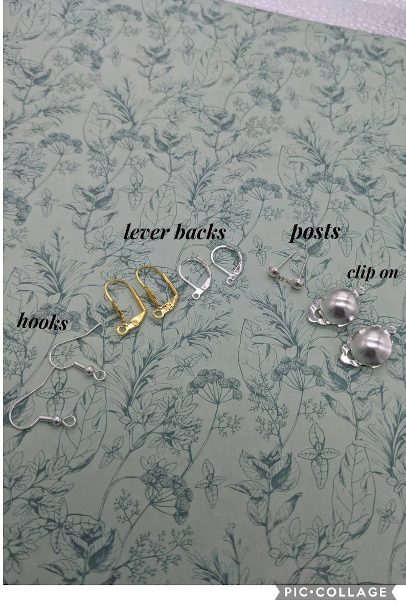 May include: A close-up of earring findings, including lever backs, posts, hooks, and clip-on earrings. The findings are arranged on a floral patterned surface.