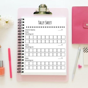 May include: A white tally sheet with black lines and the text "TALLY SHEET" at the top. The sheet is on a pink clipboard with a silver clip.