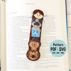 May include: A felt bookmark featuring a stack of characters from the book "The Lion, the Witch, and the Wardrobe" by C.S. Lewis. The bookmark includes a brown lion, a scarecrow, a blue character, a gray dog, and a brown-haired girl. The bookmark is labeled "Pattern PDF. SVG EPS. DXF. PNG".