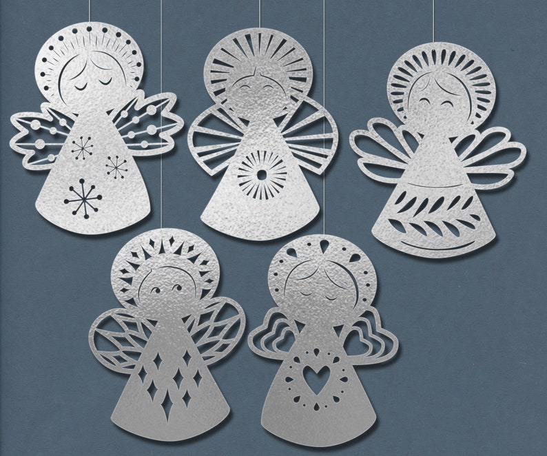 May include: Five silver paper angel ornaments with different designs. Each angel has a halo, wings, and a dress. The angels are hanging from strings.