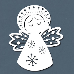 May include: White paper cut-out of an angel with a halo, closed eyes, and wings decorated with snowflakes. The angel is wearing a long gown with a snowflake pattern.