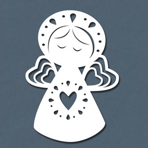 May include: White paper cut-out of an angel with a heart in the center of its chest. The angel has a halo and wings.