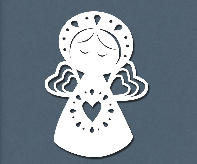 May include: White paper cut-out of an angel with a heart in the center of its chest. The angel has a halo and wings.