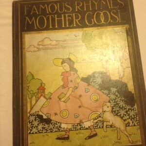 May include: A vintage book cover with the title "Famous Rhymes Mother Goose". The cover features a colorful illustration of a girl in a pink dress and a white hat, holding a book and walking with a white lamb.