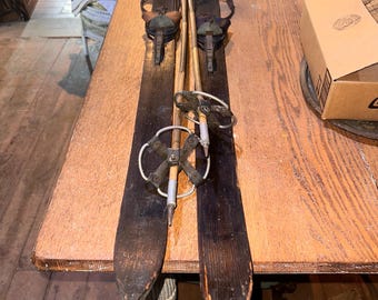 Vintage wooden Junior Skis and Poles, Skis are approximately 59” inches long poles are approximately 40” long