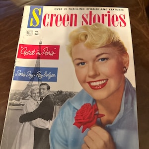 May include: A vintage magazine cover featuring Doris Day holding a red rose. The cover is titled "Screen Stories" and features the text "April in Paris" with the names Doris Day and Ray Bolger. The magazine is from February and costs 20 cents.