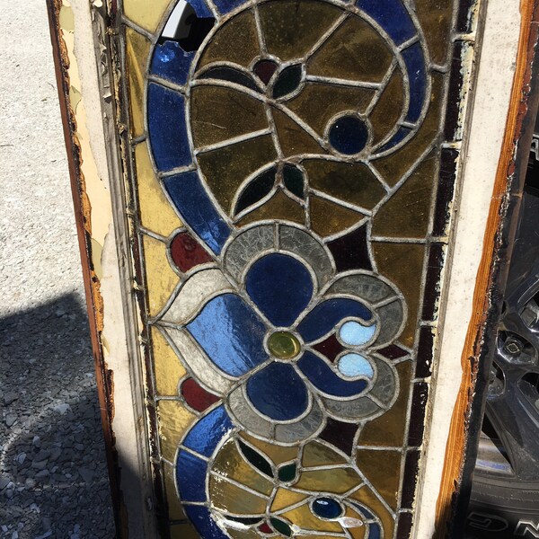 Very Old Stained Glass Window, measures approx, 38” wide x 18” tall x 1 3/8” thick, one blue pane broke