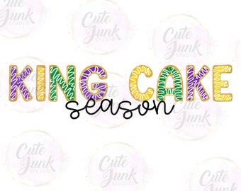 May include: King Cake season text with purple, green, and gold lettering. The letters are outlined in gold and have a swirl pattern.