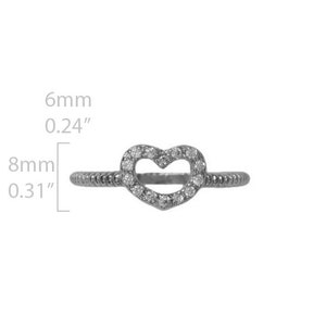 May include: A silver ring with a heart-shaped design. The heart is outlined with small clear stones. The ring is 6mm wide and 8mm in diameter.