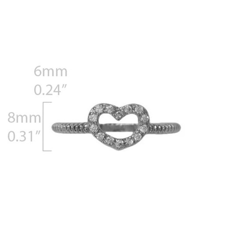 May include: A silver ring with a heart-shaped design. The heart is outlined with small clear stones. The ring is 6mm wide and 8mm in diameter.