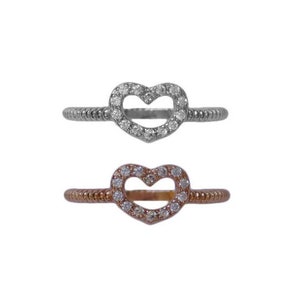 May include: Two heart-shaped rings with a clear stone setting. The ring on top is silver, and the ring on the bottom is rose gold.