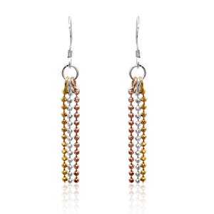 May include: A pair of dangle earrings with a tri-color design. Each earring features three strands of small, round beads in gold, silver, and rose gold. The earrings have a silver hook and a small ring connecting the beads.