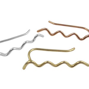 May include: Ear climbers in silver, copper, and gold tones. Each earring features a wavy design that curves up the ear. The earrings are simple and elegant, suitable for everyday wear.