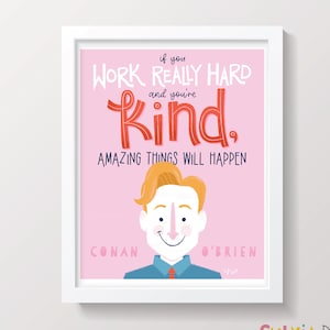 May include: A pink and white framed print with a cartoon illustration of Conan O'Brien. The quote "If you work really hard and you're kind, amazing things will happen." is written in red and blue lettering.
