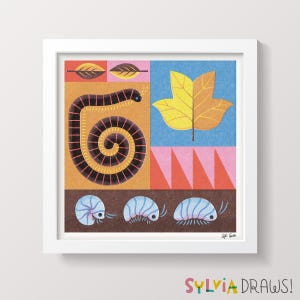 May include: Square framed art print featuring a colorful, geometric design. The artwork includes a stylized centipede, a large leaf, and several pill bugs. The color palette includes orange, blue, pink, and brown. The text "SYLVIA DRAWS!" is at the bottom.