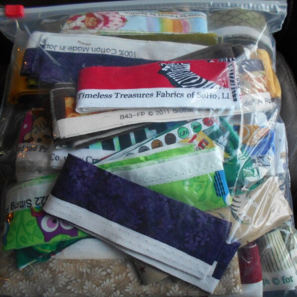 FABRIC SELVAGES  One Gallon ZipLoc Bag.  Most pieces are over a half yard.  All selvages cut 1 1/2 inch wide