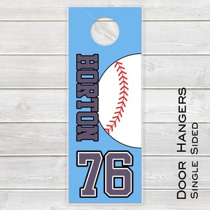 May include: A light blue door hanger with a baseball design. The word "HORTON" is printed vertically in purple and white. The number "76" is below the name. The words "DOOR HANGERS SINGLE SIDED" are printed vertically on the right side.