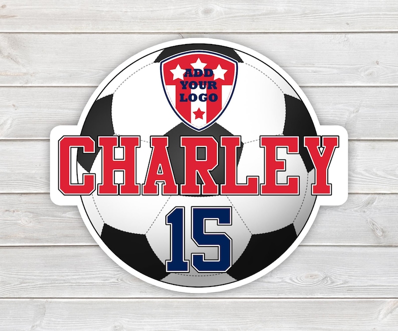 May include: A round sticker featuring a soccer ball design with the name "CHARLEY" in red block letters. The number "15" is in blue. A red, white, and blue crest at the top reads "ADD YOUR LOGO". The sticker is on a white wood grain background.