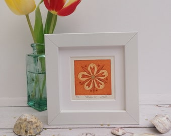 Bloom II, small framed original light orange flower collagraph print with gold embellishments