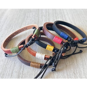 May include: Five leather bracelets with different colored threads and a black cord. One bracelet has the inscription "Do or Do Not. There is No Try."