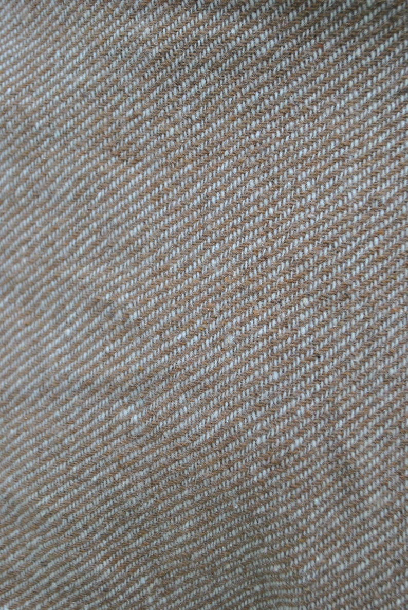 May include: Close-up of a brown and white woven fabric with a diagonal pattern.