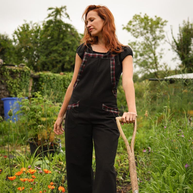 Embrace folklore fashion with our Meadow Black Dungarees, a breathable black jumpsuit made from natural cotton and detailed with heritage-inspired tweed trims, the perfect cotton overalls for everyday layering.