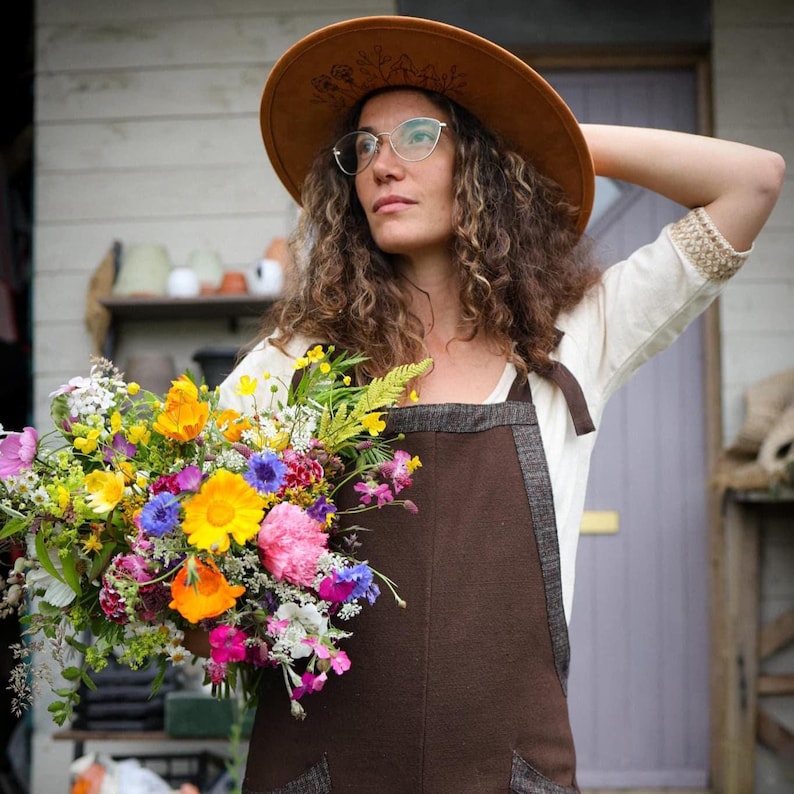 Discover our Meadow Brown Dungarees, an earthy brown jumpsuit trimmed with oak tweed, designed for folklore-inspired style, comfort, and everyday wear.