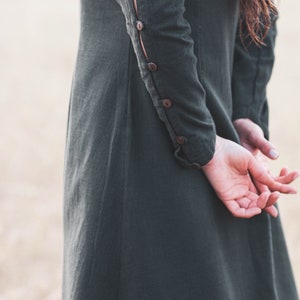 Detail of sleeve buttons on a green Celtic dress, showing the craftsmanship of this breathable long sleeve folklore dress.