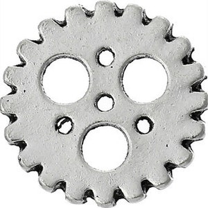 May include: Silver gear charm with three holes in the center. The gear has a smooth, metallic finish.