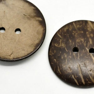 May include: Two brown coconut shell buttons with two holes each.