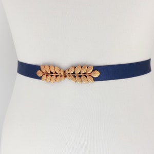 Navy blue elastic waist belt with rose gold leaf clasp