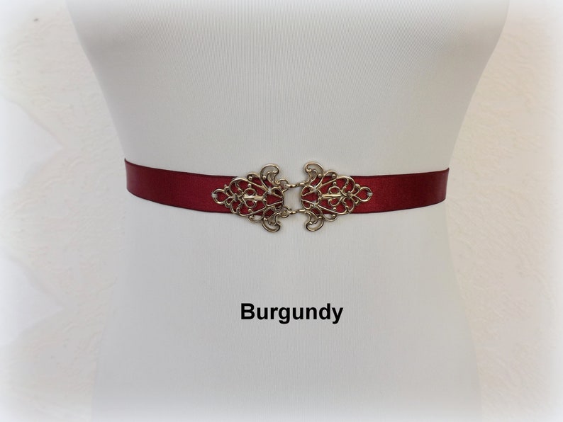 Black elastic waist belt with silver filigree clasp