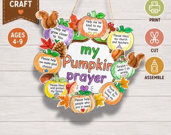 May include: A DIY wreath craft kit featuring a central sign that reads My Pumpkin Prayer. The design includes multiple paper pumpkins, each with printed text, surrounded by illustrations of squirrels, acorns, mushrooms, and autumn leaves.